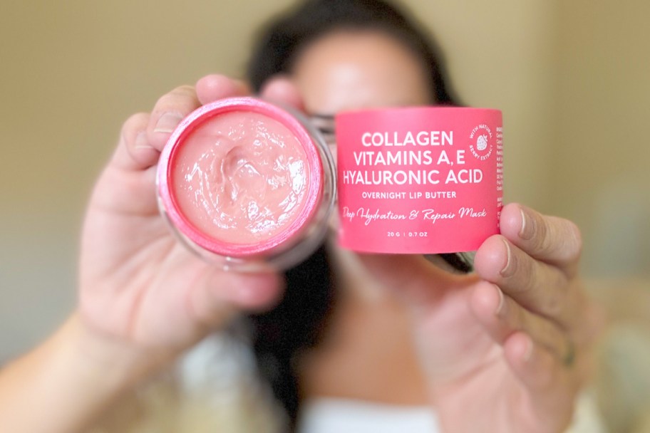 woman holding lip butter in front of face