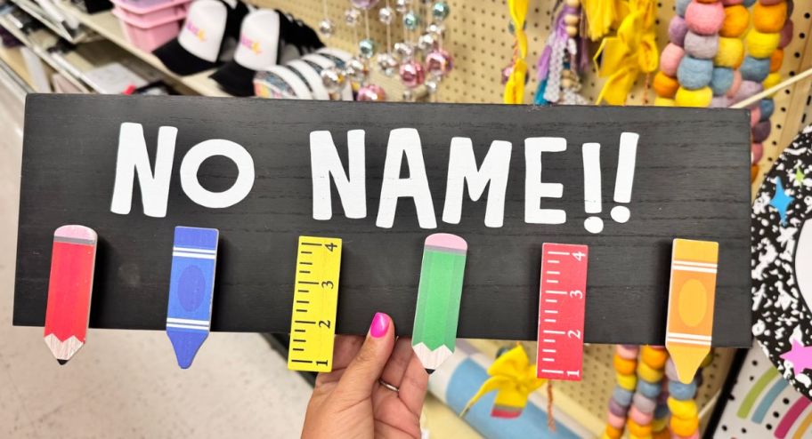 hand holding a no name wall decor