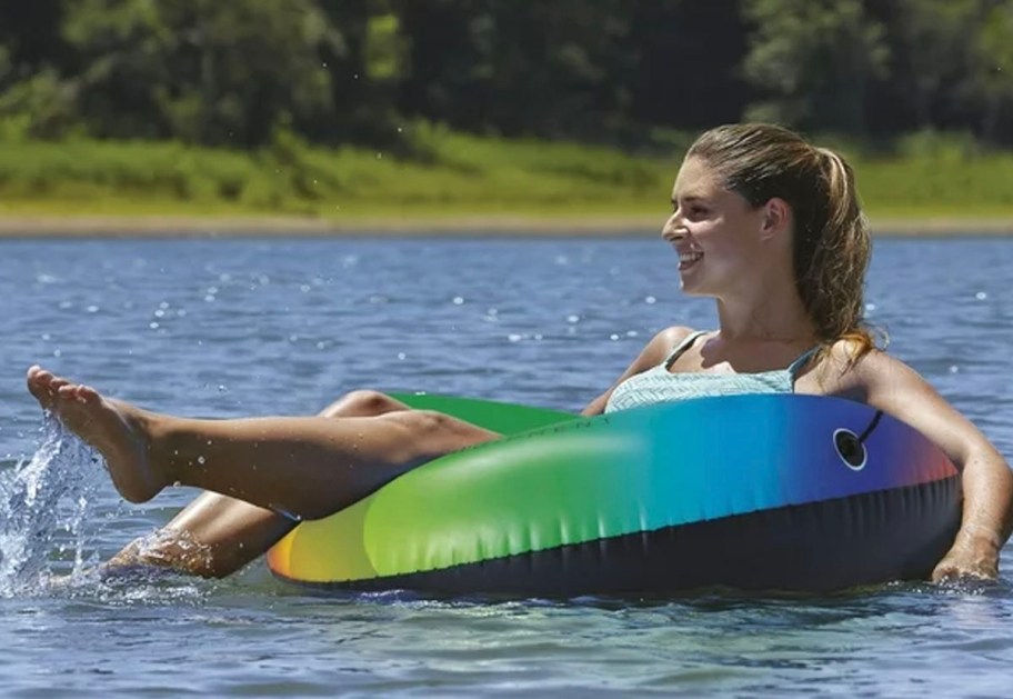 woman in rainbow float in water