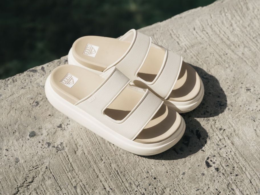 beige reef sandals on concrete