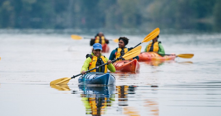 people kayaking on a river