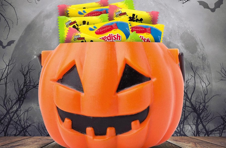 sour patch and swedish fish candy in pumpkin bucket 