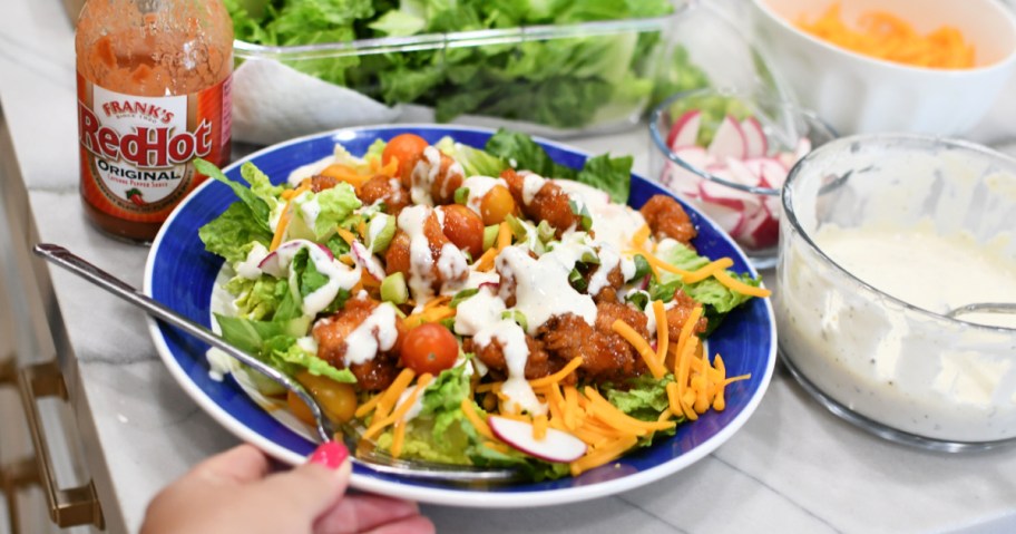 sticky chicken finger salad on a plate 