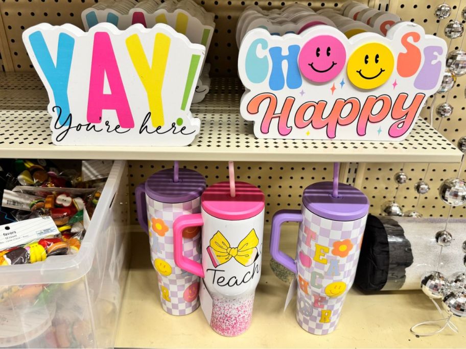 teacher signs and tumblers displayed at the store