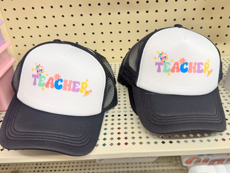 two teacher trucker hats on display at the store