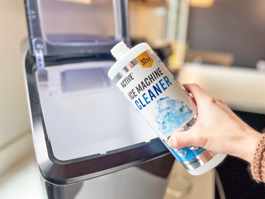 pouring bottle of Active Ice Machine Cleaner into ice machine