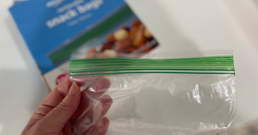 person holding up single Amazon Basics Sandwich Bag