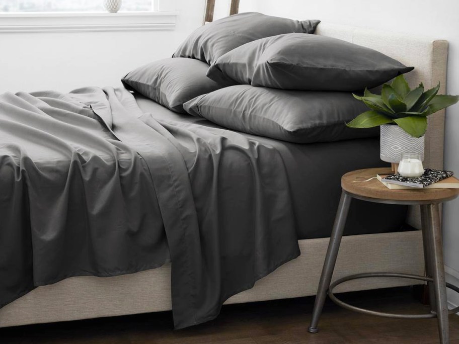 set of dark grey sheets and pillows on a bed