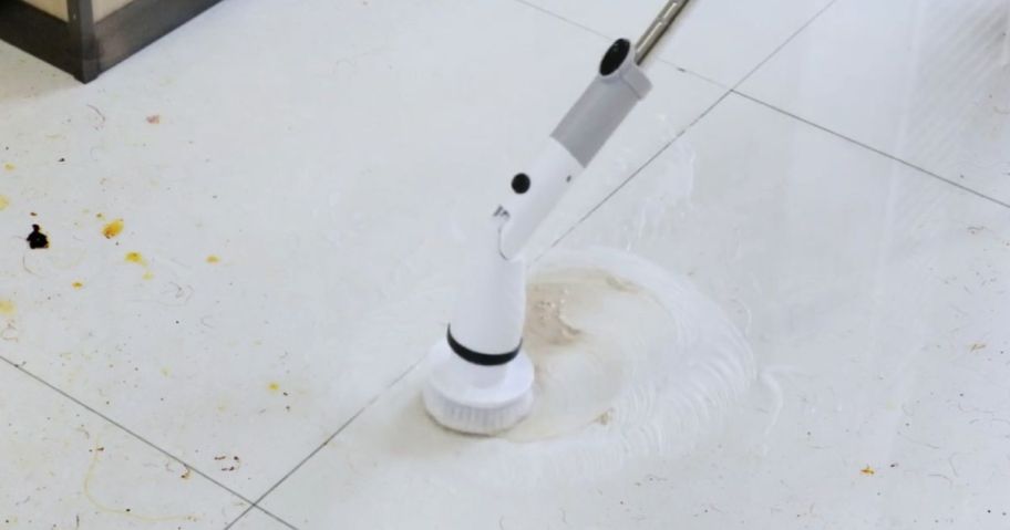 person using electric scrubber on floor