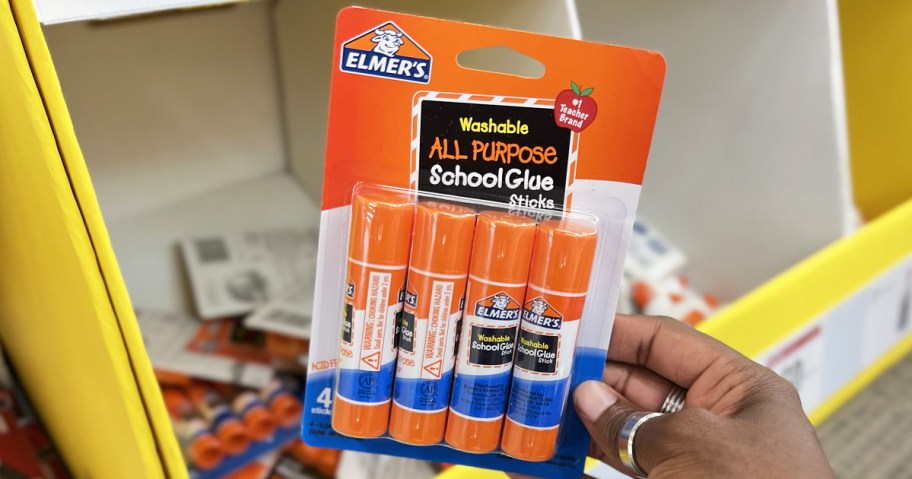 hand holding up a Elmer's Glue Sticks 4-Pack in store