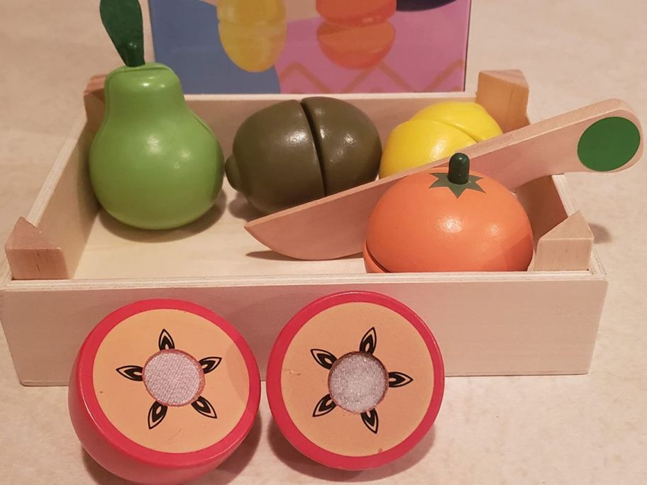 A box full of wooden play fruit 