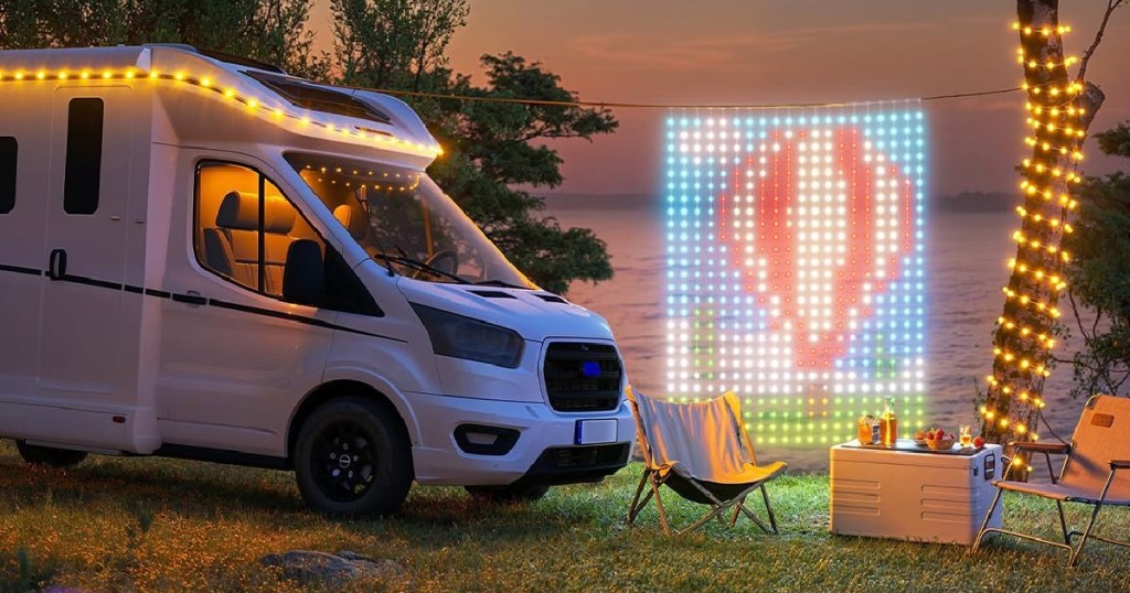 colorful curtain of lights featuring hot air balloon hanging outside by rv trailer