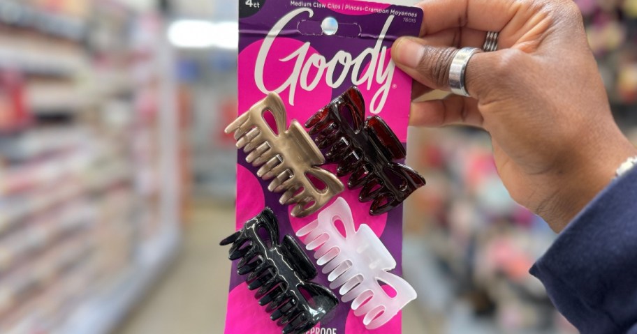 hand holding a 4 pack of Goody Hair Claw Clips on the paper packaging