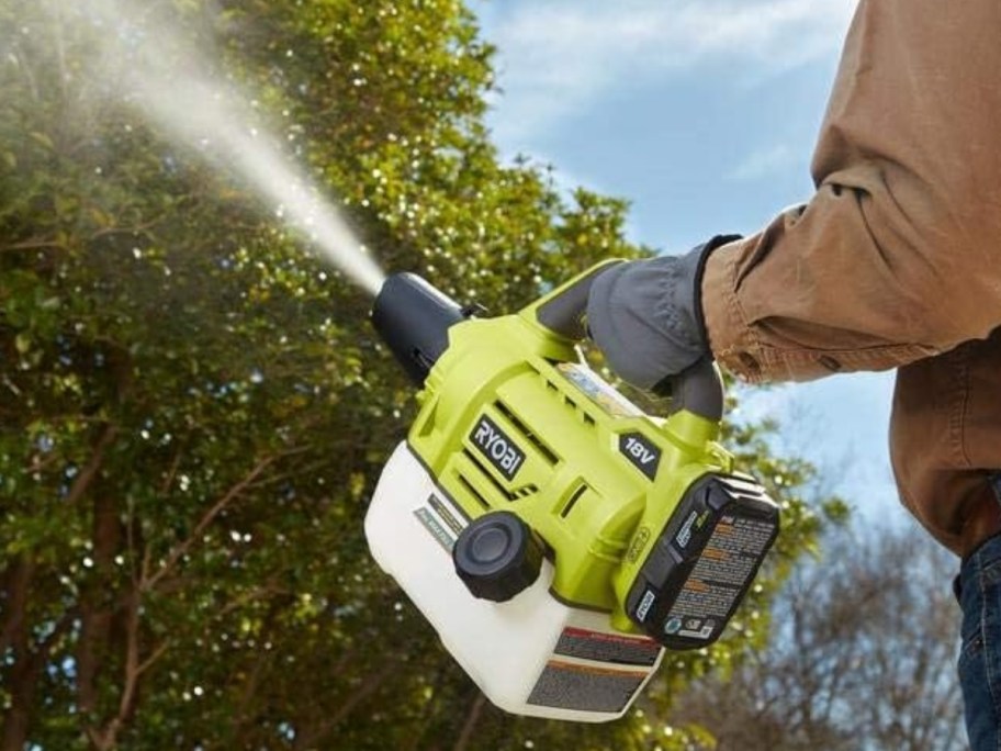 man spraying weed killer on yard with a Ryobi fogger/mister tool