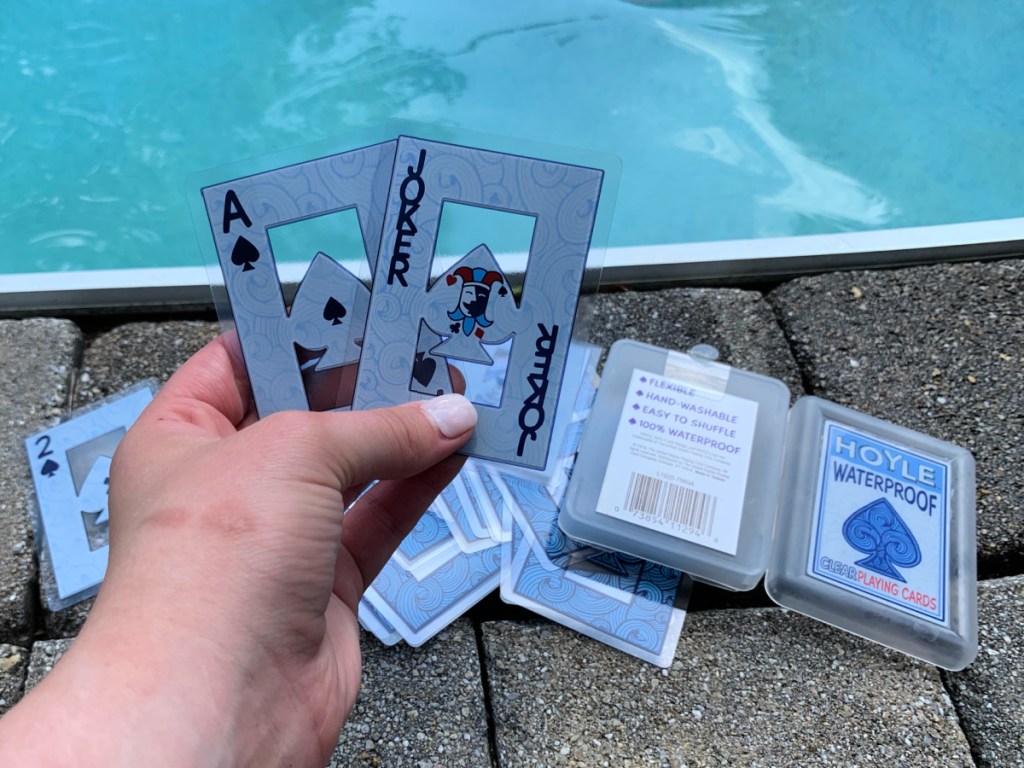 Person holding up waterproof playing cards