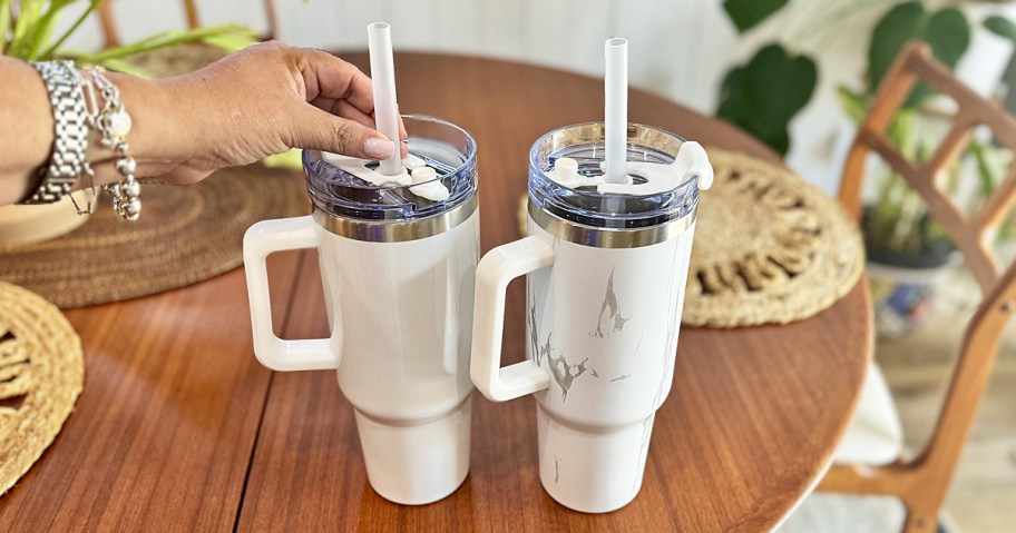 two white 40oz tumblers on wood table