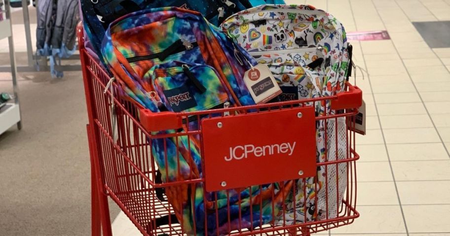 A JCpenney Shopping cart filled with Jansport Backpacks