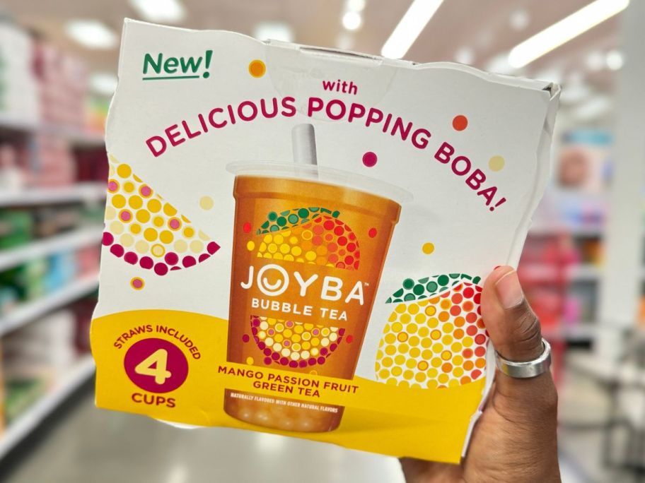 Hand holding up a box of Joyba Bubble Tea in Mango Passion Fruit Flavor