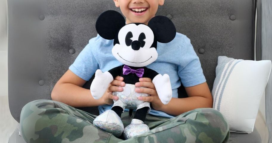 child holding Just Play Disney100 Years of Wonder Mickey Mouse Large Plush