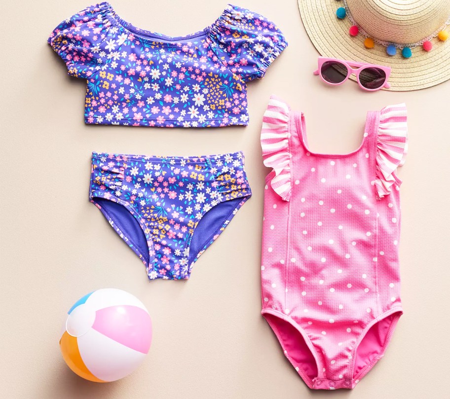 purple floral print 2-piece bathing suit and pink polkadot one-piece bathing suit