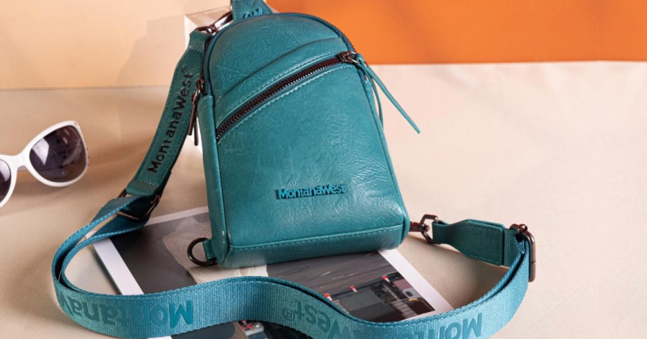Blue Mountain West tote bag on countertop next to pair of sunglasses