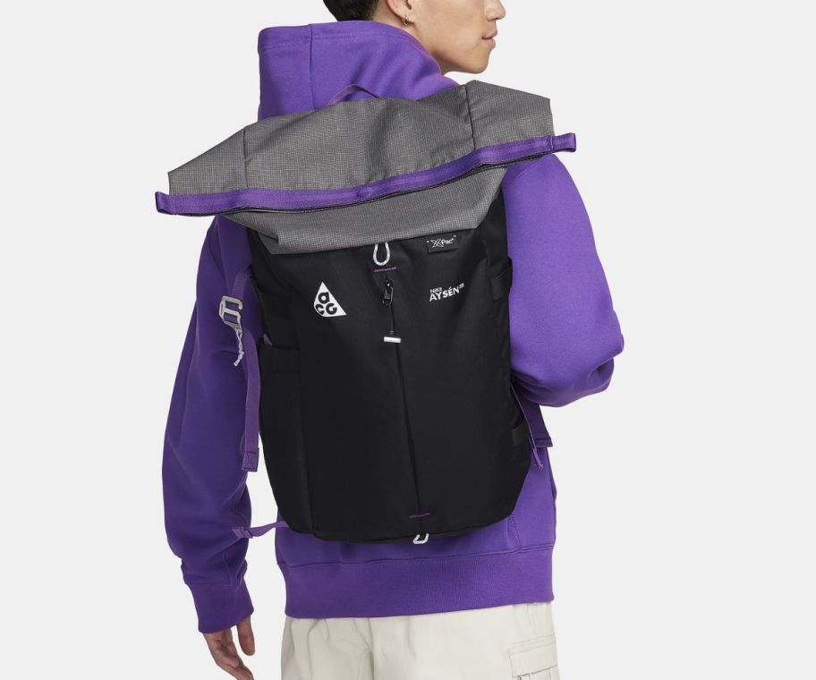 a teen with a black and purple backack