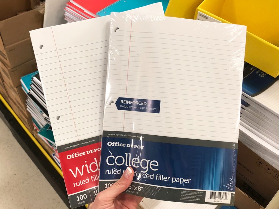 hand holding up 2 packs of Office Depot Filler Paper