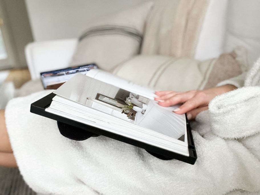 hand holding book on Portable Lap Desk