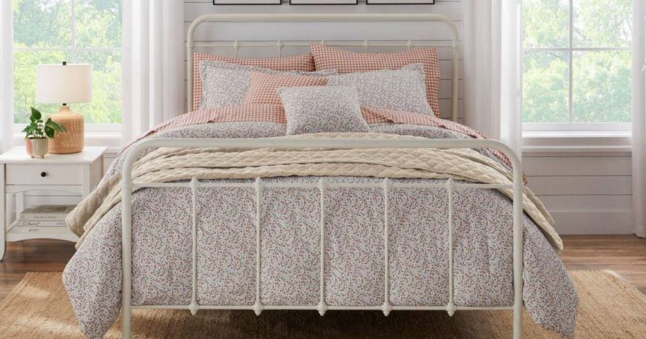 A bed with a floral comforter