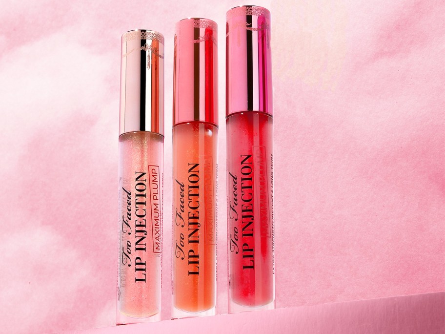 light pink, orange, and dark pink tubes of Too Faced Lip Injection Maximum Plump Lip Plumper