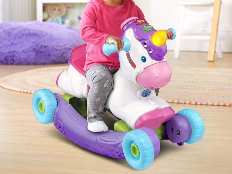 A child riding on a VTech Prance and Rock Learning Unicorn
