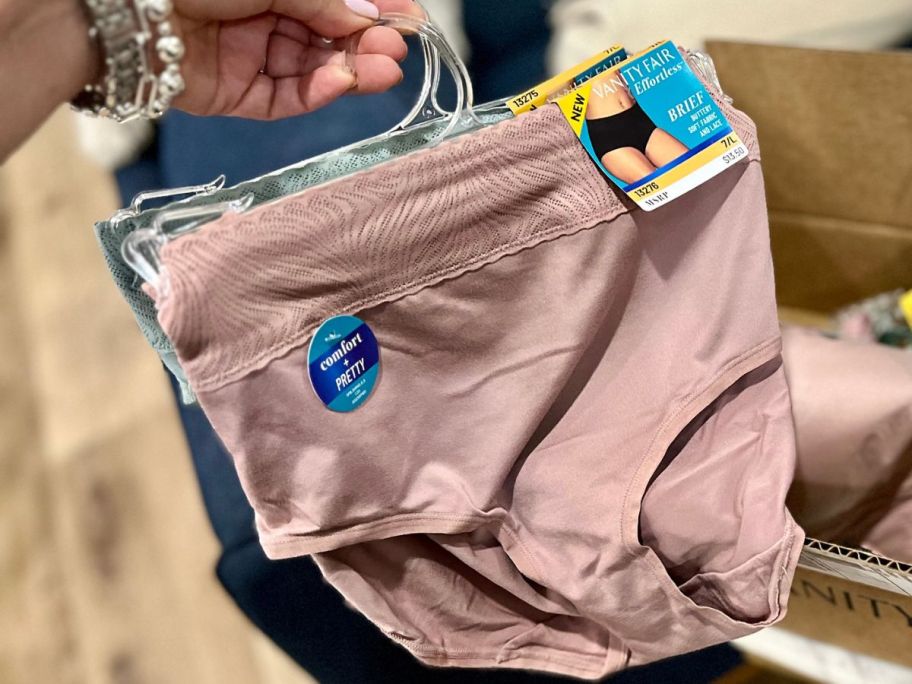 Hand holding a hanger with Vanity Fair Effortless Panties on it