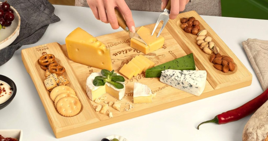 wooden board filled with cheeses and nuts on tabletop