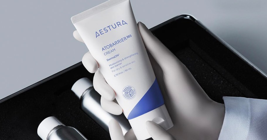 hand holding aestura cream 