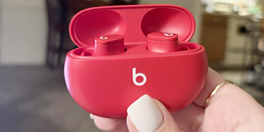 hand holding red beats earbuds 
