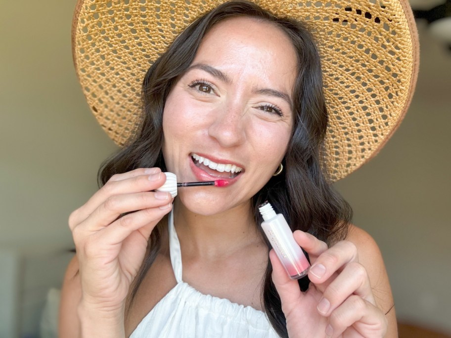 woman applying lip tint