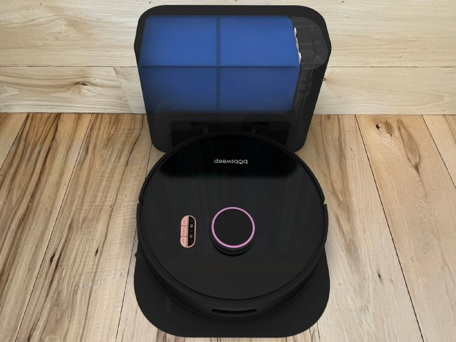 black robot vacuum on dock in room 