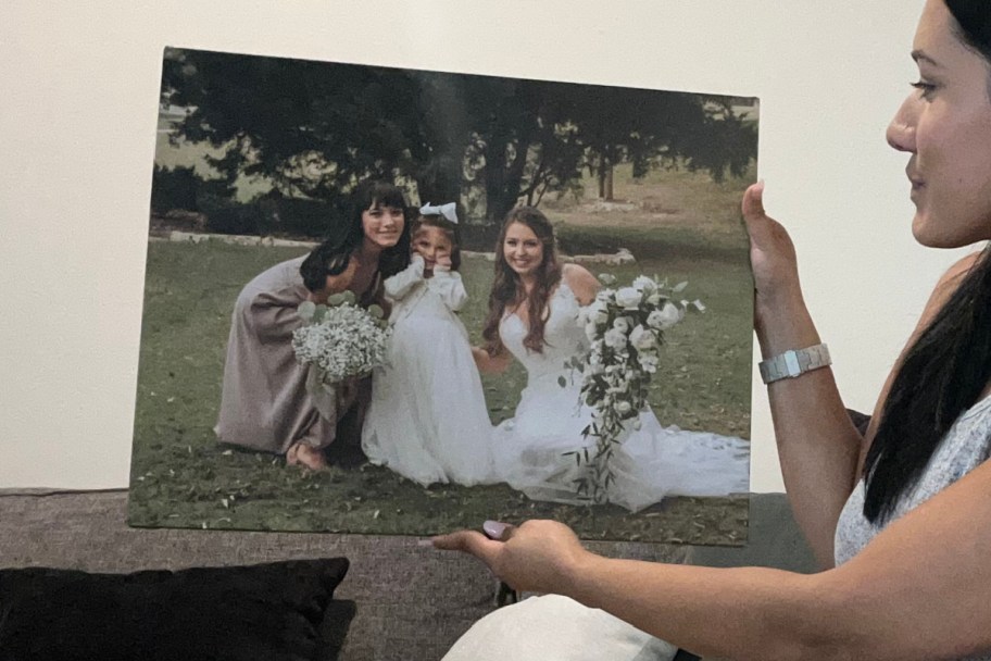 woman holding up canvas print 