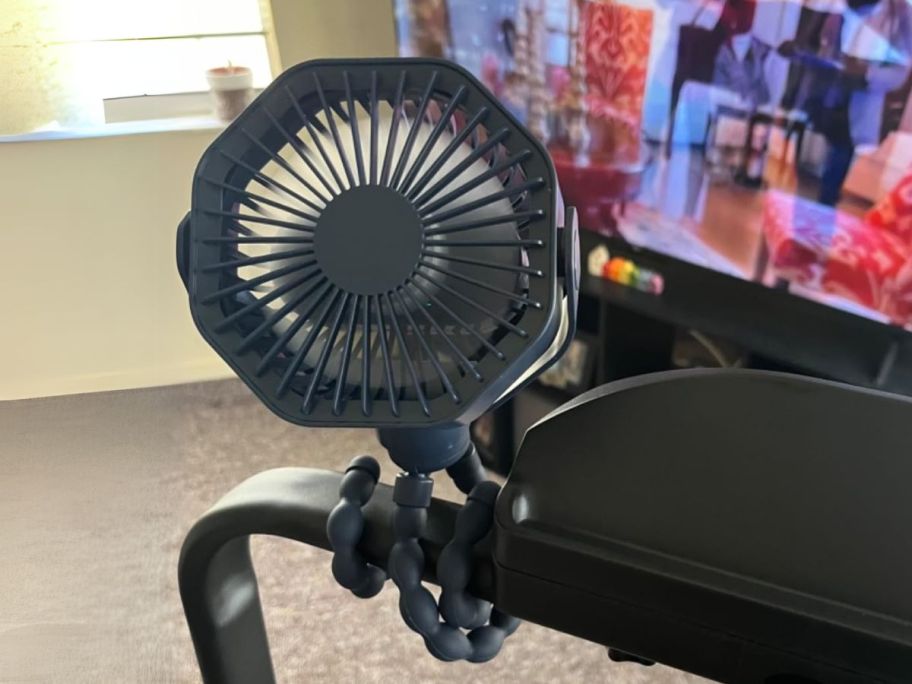 Lerat Store Portable Stroller Fan in Black w/ Flexible Tripod clipped on treadmill