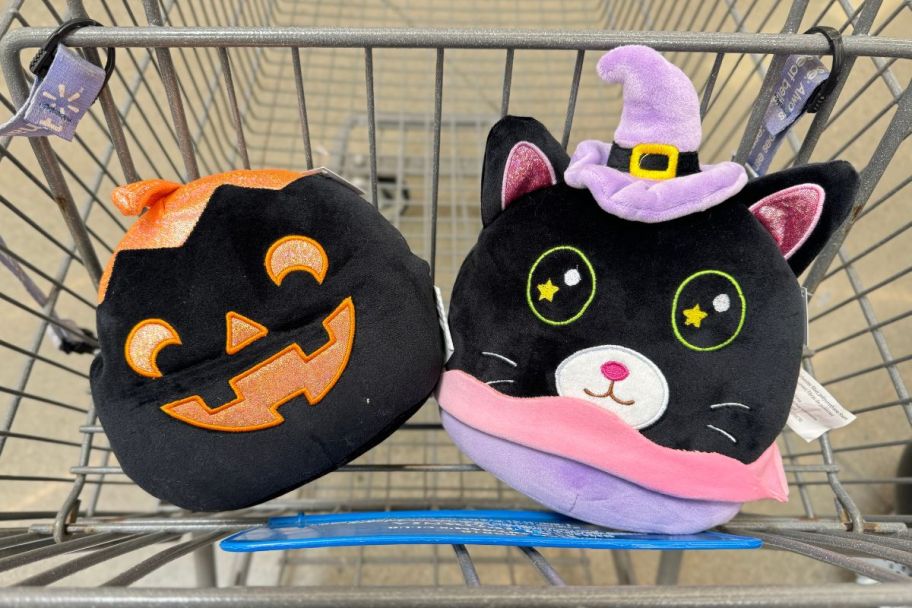 cat and jack o lantern throw pillows in a shopping cart