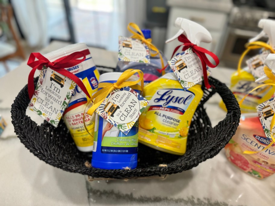 black basket full of cleaning supplies with clean start gift tags for back to school gifting