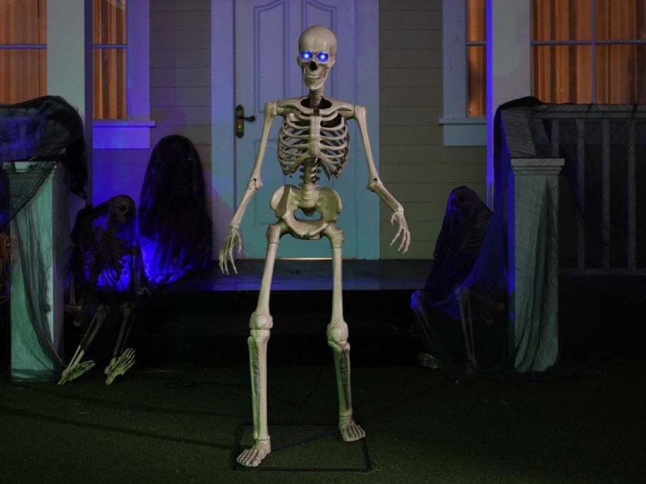 the front of a house with a 5 Ft animated light up skeleton Halloween decor