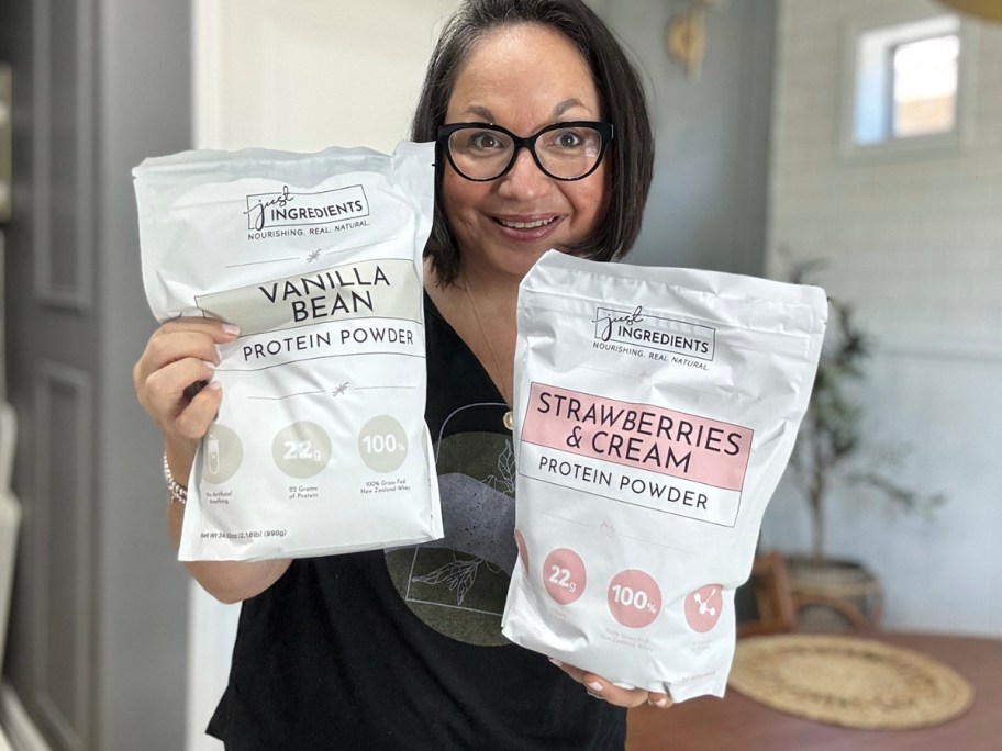 woman holding two protein powder bags