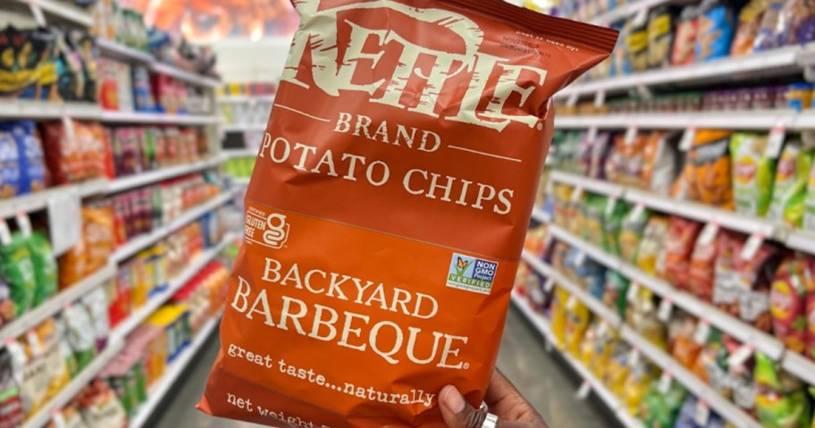 hand holding bag of barbecue kettle chips 