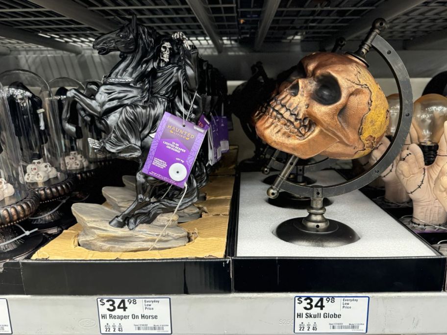 a reaper on a horse and a skull on a globe stand table top decor