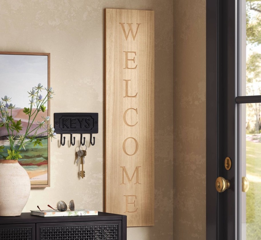 wood welcome sign near door