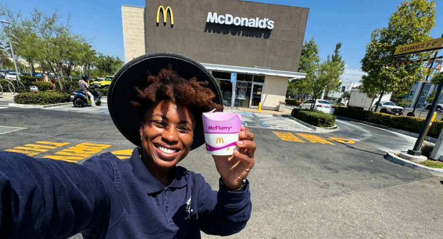 woman showing new mcflurry cup in front of McDonalds