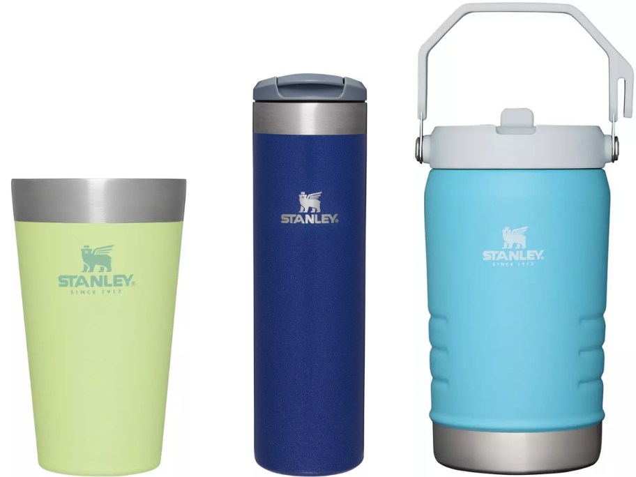 yellow and green Stanley pint cup, dark blue Stanley water bottle, and light blue large Stanley jug