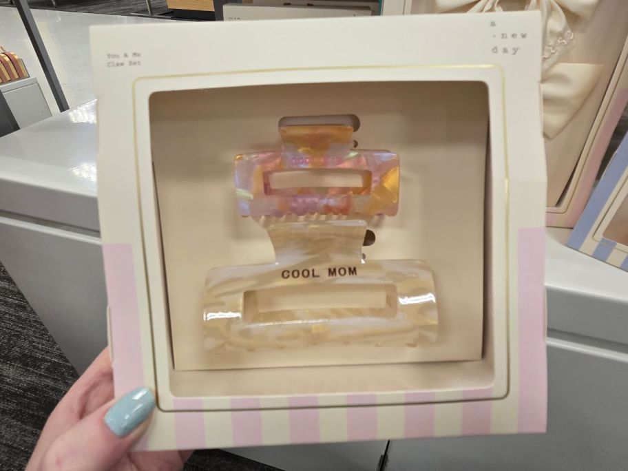 A person holding a box including hair claws