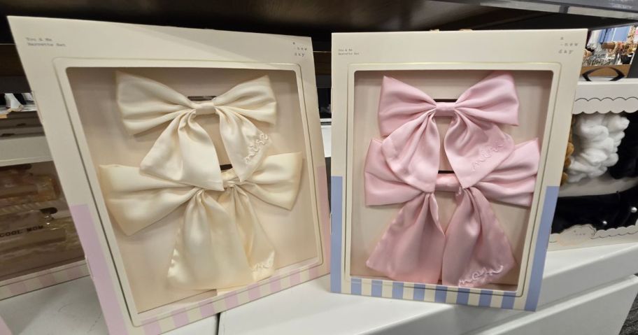 Two boxes of pink and cream hair bows